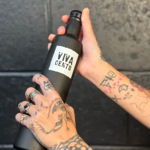 woman holding Viva Cento olive oil bottle